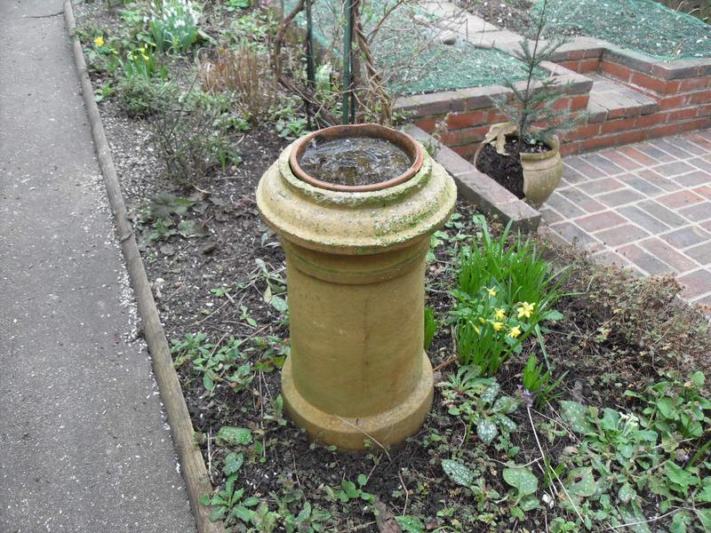 Old bird bath with the rim broken away