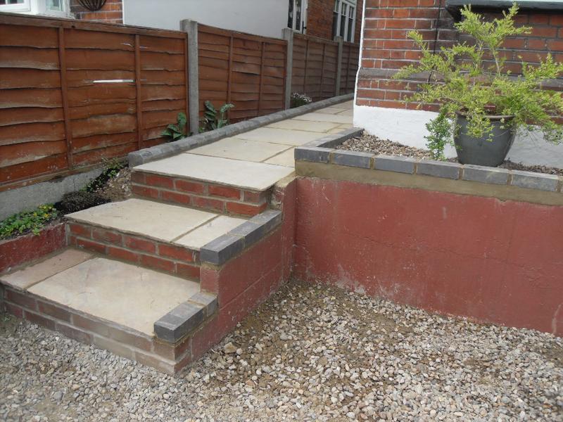 The wall and steps are topped with grey engineering bricks